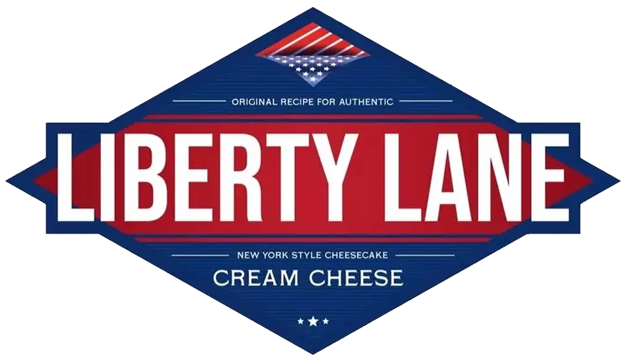 Liberty Lane cream cheese logo featuring a diamond-shaped badge with red, white, and blue American flag design and text indicating New York style cheesecake product.